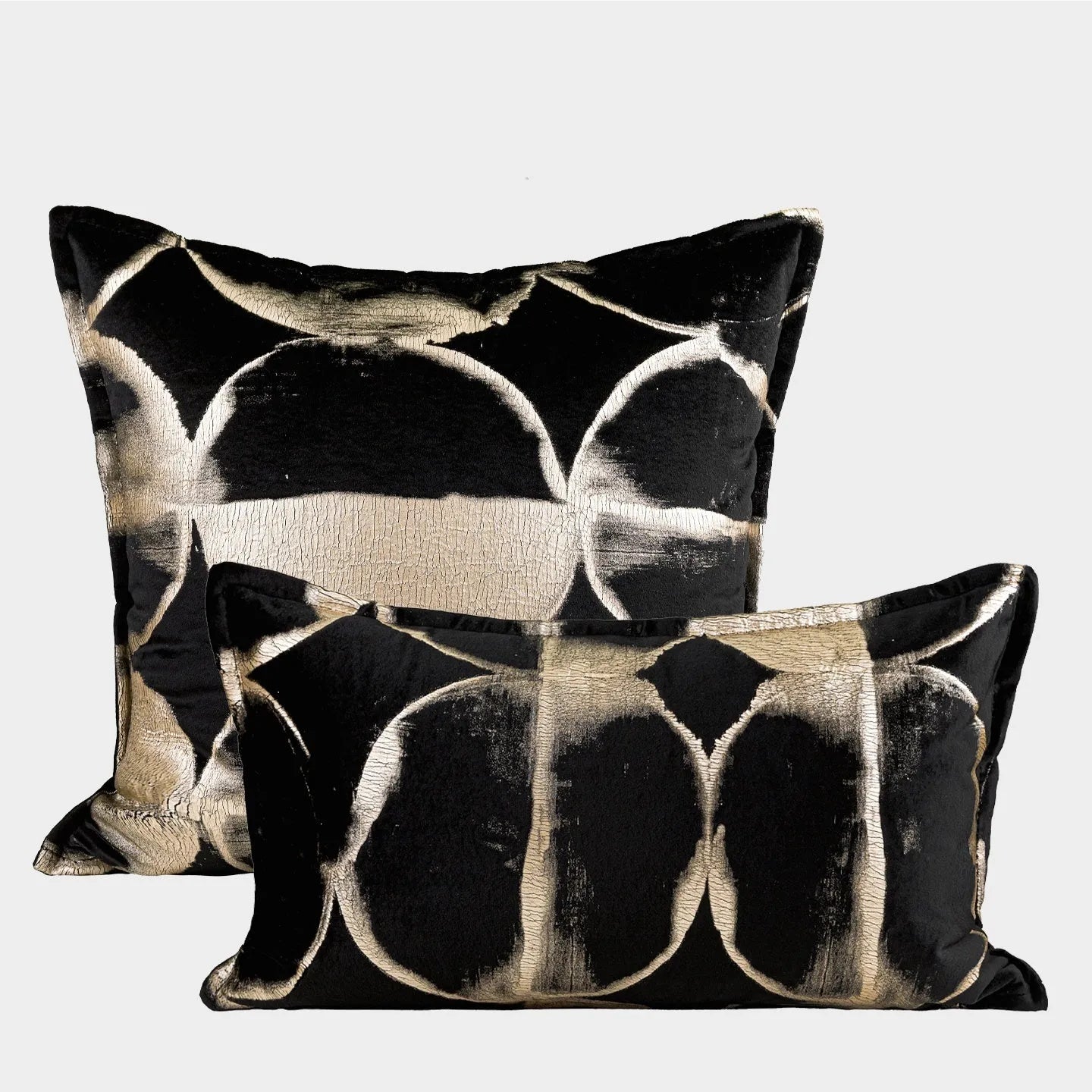 Black gold abstract pattern decorative flannel cushion on a sofa, showing removable cover.