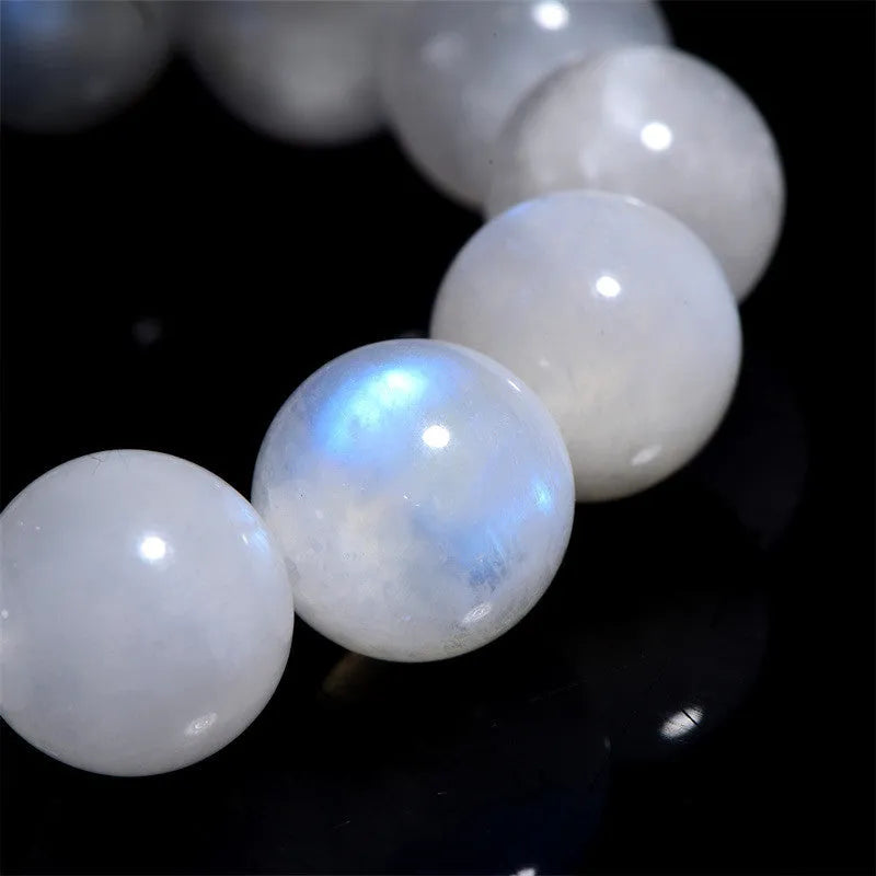 Natural blue moonstone bracelet with polished round beads showing sizing from 5mm to 12mm diameter