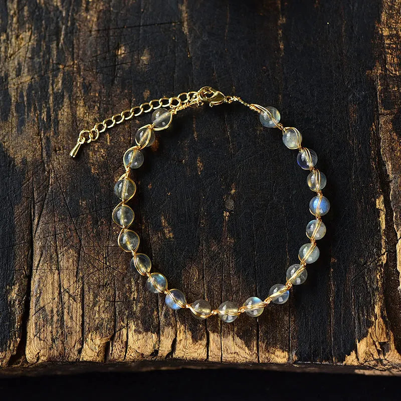 Women's blue moonstone bracelet with 6mm crystal and 14K gold-plated gilded metal band.