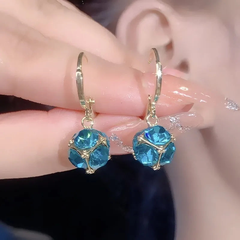 Women's geometric copper earrings with zircon and rose design elements in various colours