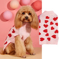 Small dog wearing a pink acrylic sweater with a bow and love heart design in ins style