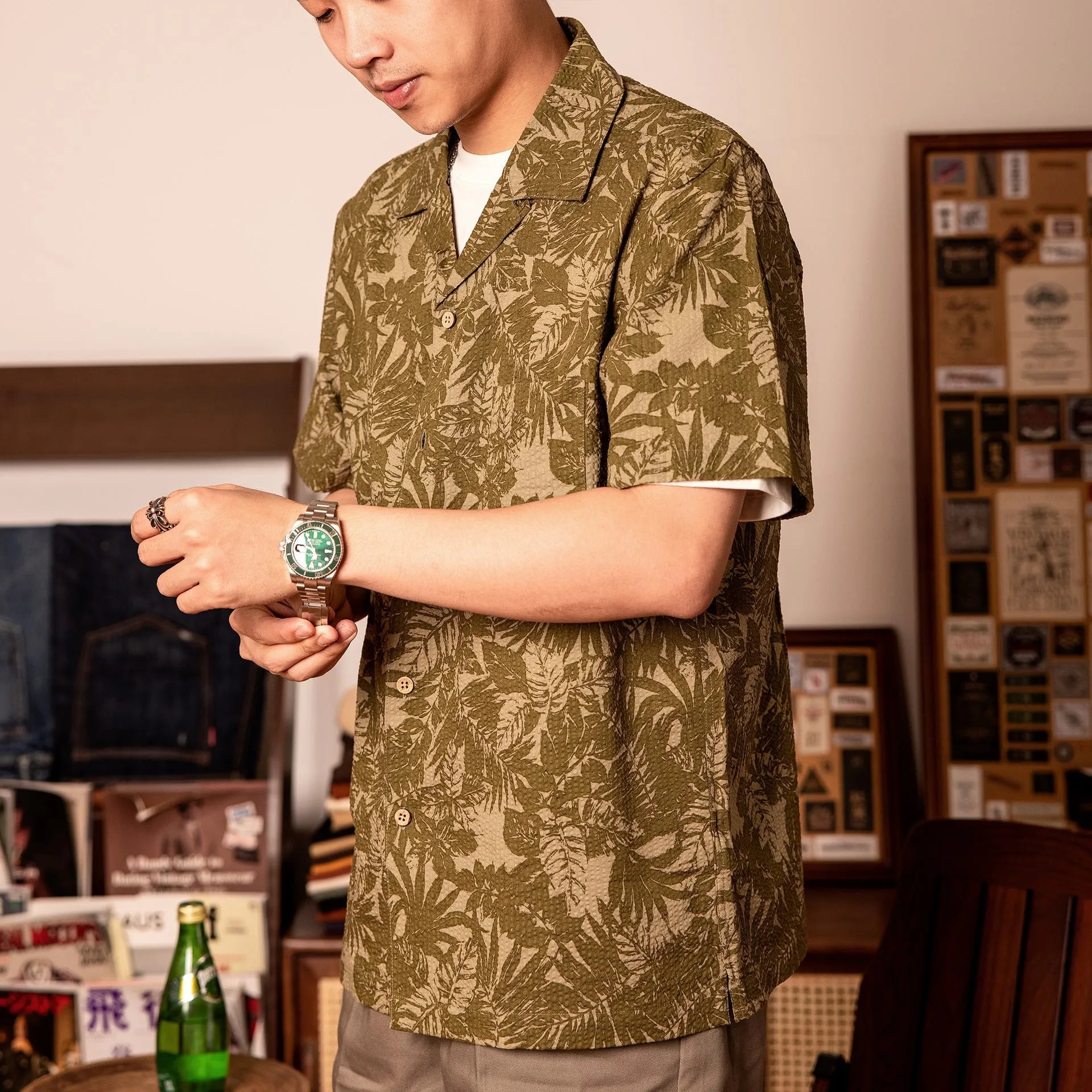 Man wearing a vintage green seersucker shirt with floral print and a Cuban collar.