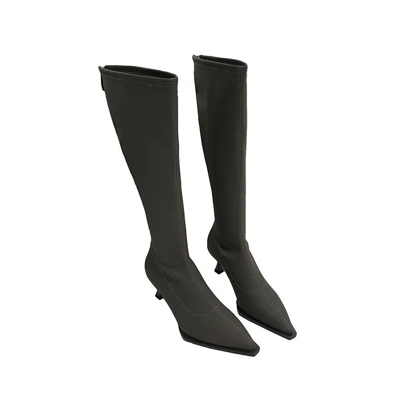 Women's black pointed toe stiletto heel boots with a back zipper, shown below the knee.