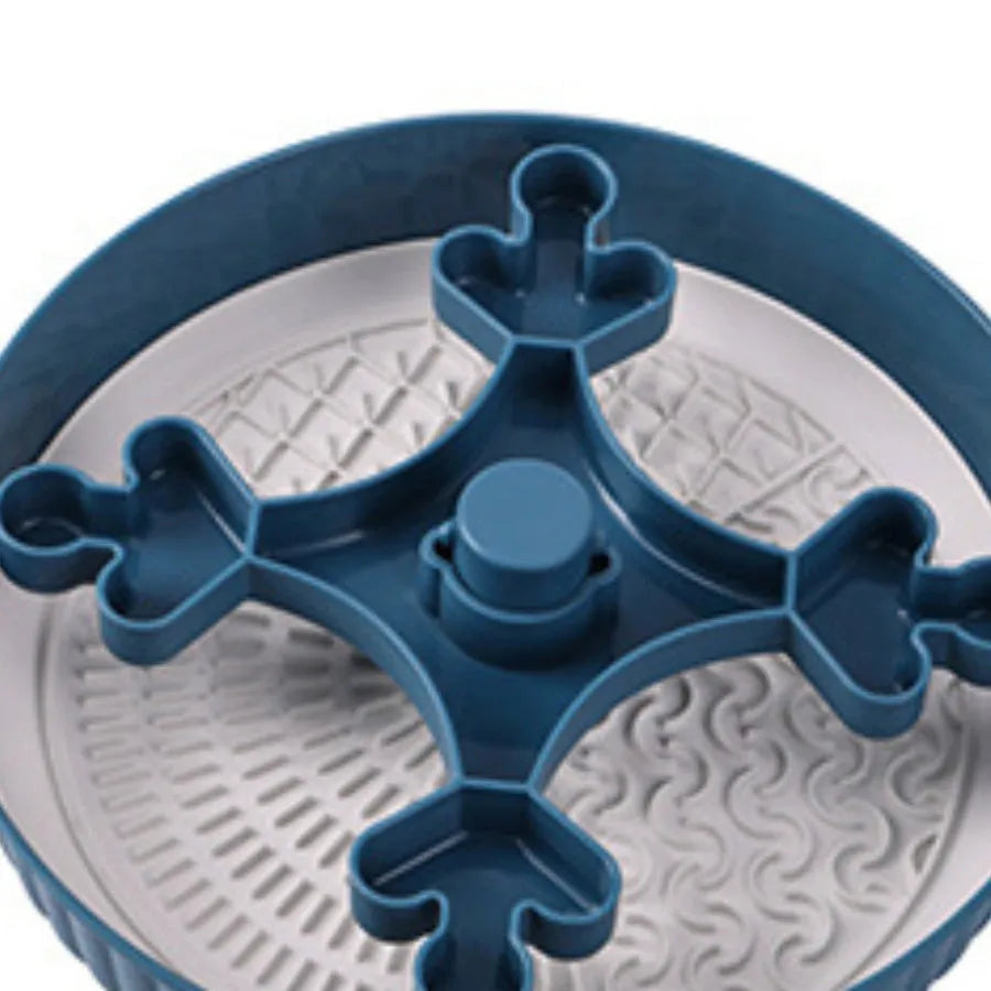 Rotating pet food bowl with silicone slow feeder mat in blue with windmill pattern design