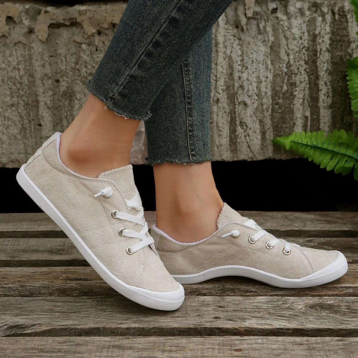 Women's creamy white low-top casual sneakers with fabric upper and rubber sole