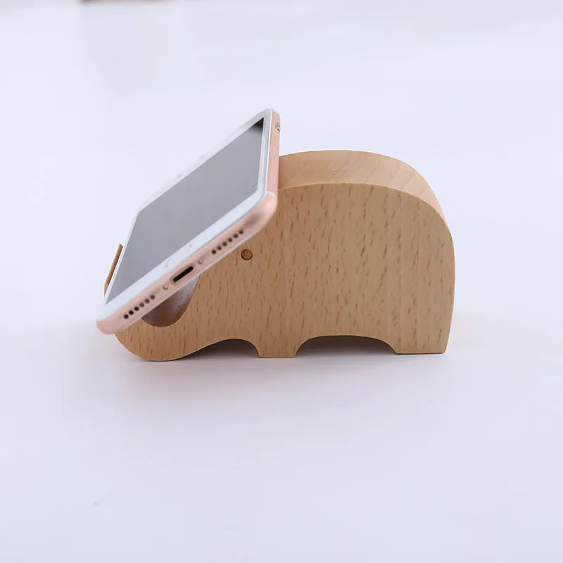 Beech wood mobile phone holder stand with coin slot and decorative carving.