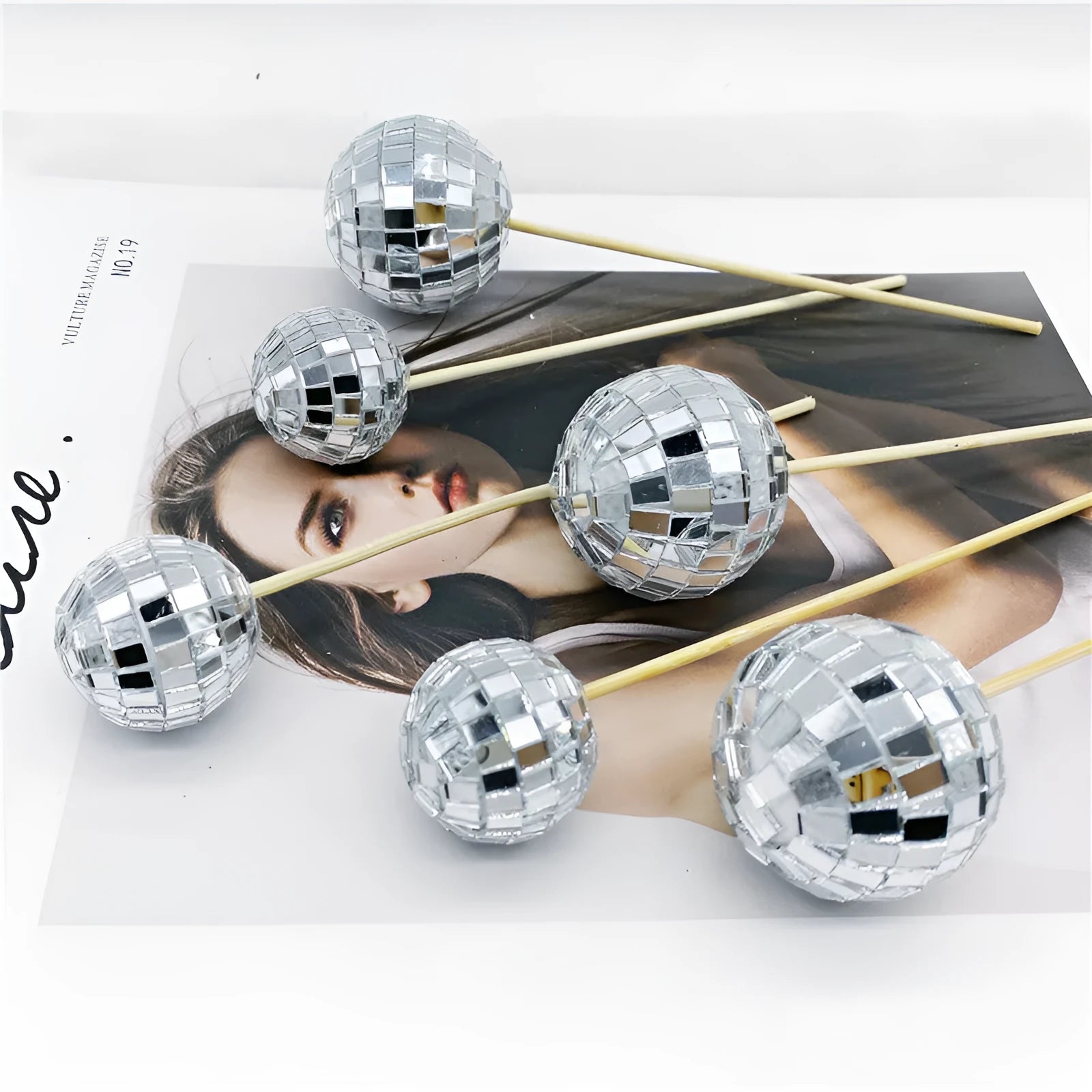 Glass mirror ball cake decoration on a wooden stick in various sizes for birthday and party cakes.