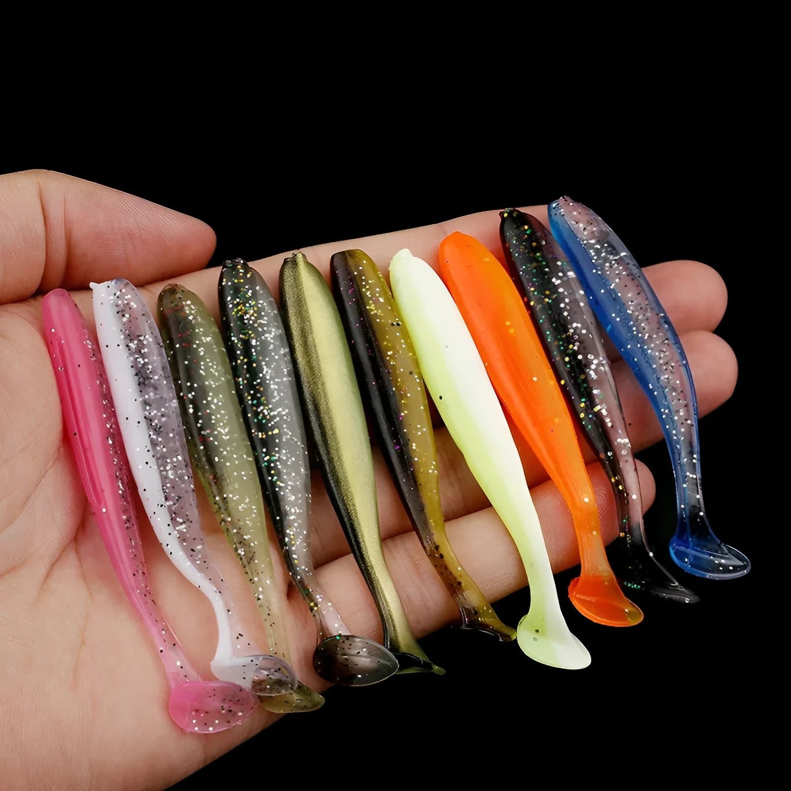 Soft plastic T-tail fishing lure in two-tone mandarin fish pattern, 7cm long.