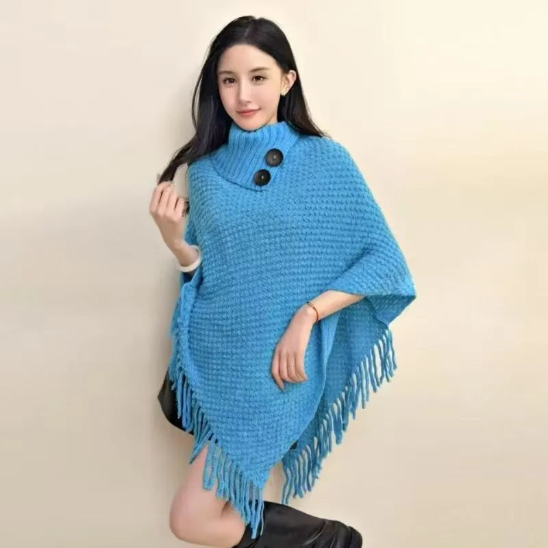 Women's triangular plush shawl cape in a cashmere blend with tassel detailing.
