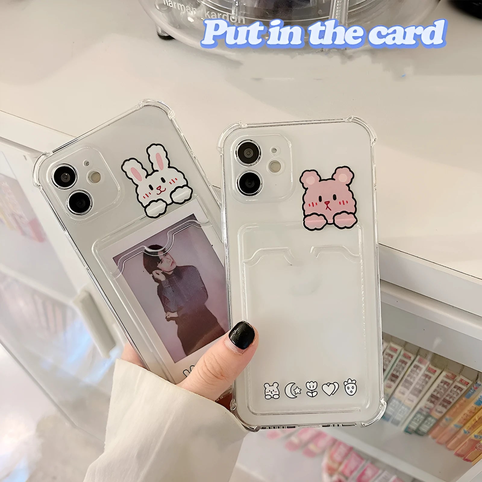 Transparent cartoon-design phone case with a card slot on the back, fitted on an iPhone.