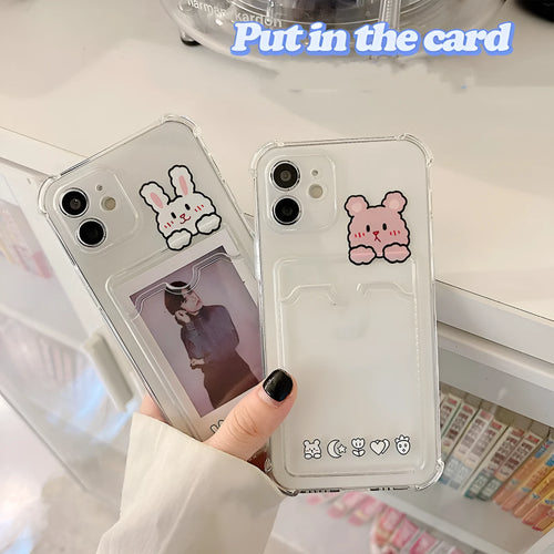 Transparent cartoon-design phone case with a card slot on the back, fitted on an iPhone.