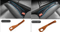 Black plastic car seat gap storage box with handle installed between car seats