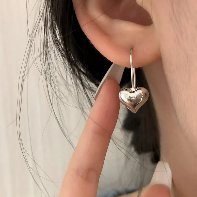 Three-dimensional glossy heart-shaped earrings in silver colour made from copper with white gold finish, Korean style for women