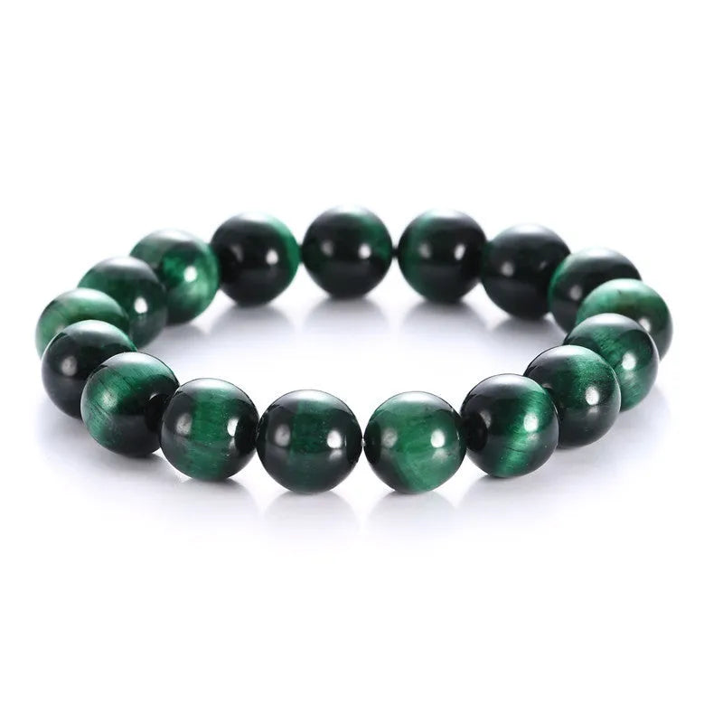 Green Tiger Eye stone beaded bracelet showing polished geometric beads on a wrist.