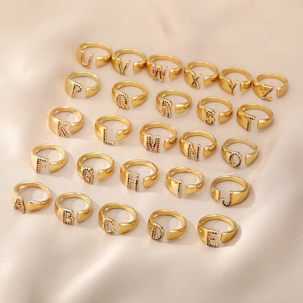 Fashion micro-set colored zirconium adjustable open ring showing letter A on a copper electroplated base