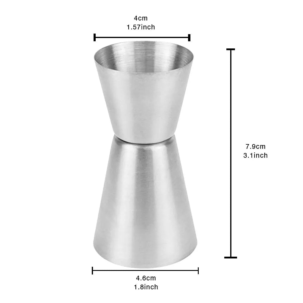Double-headed stainless steel measuring cup and shaker on a bar counter for cocktail preparation