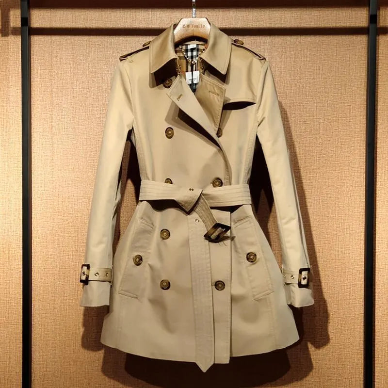 Khaki double-breasted women's trench coat with long flight sleeves, shown on a hanger.