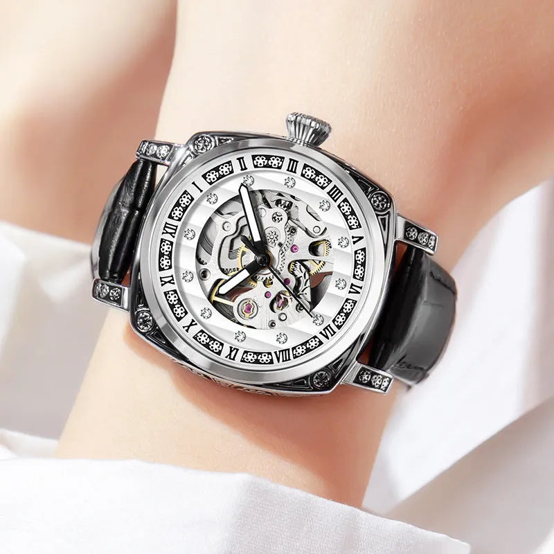 Mechanical watch with luminous hands on a leather strap, showing colour options of black, red, steel, and white dials.