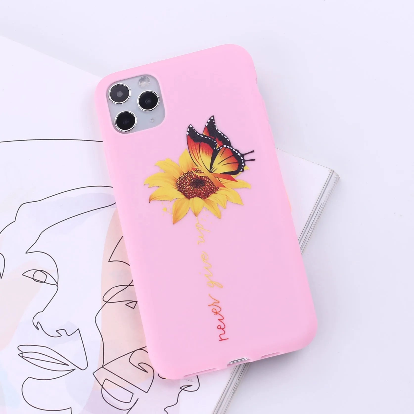 Slim TPU mobile phone case for iPhone on a table, showing one of 14 available colour options.