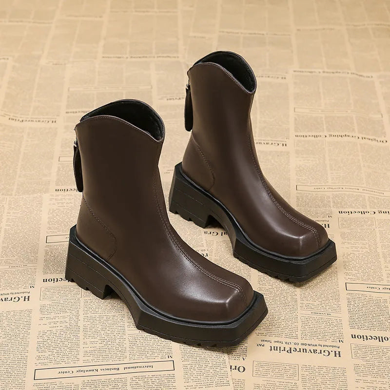 Black platform Martin boots for women with a square toe, mid calf length, and a high heel.