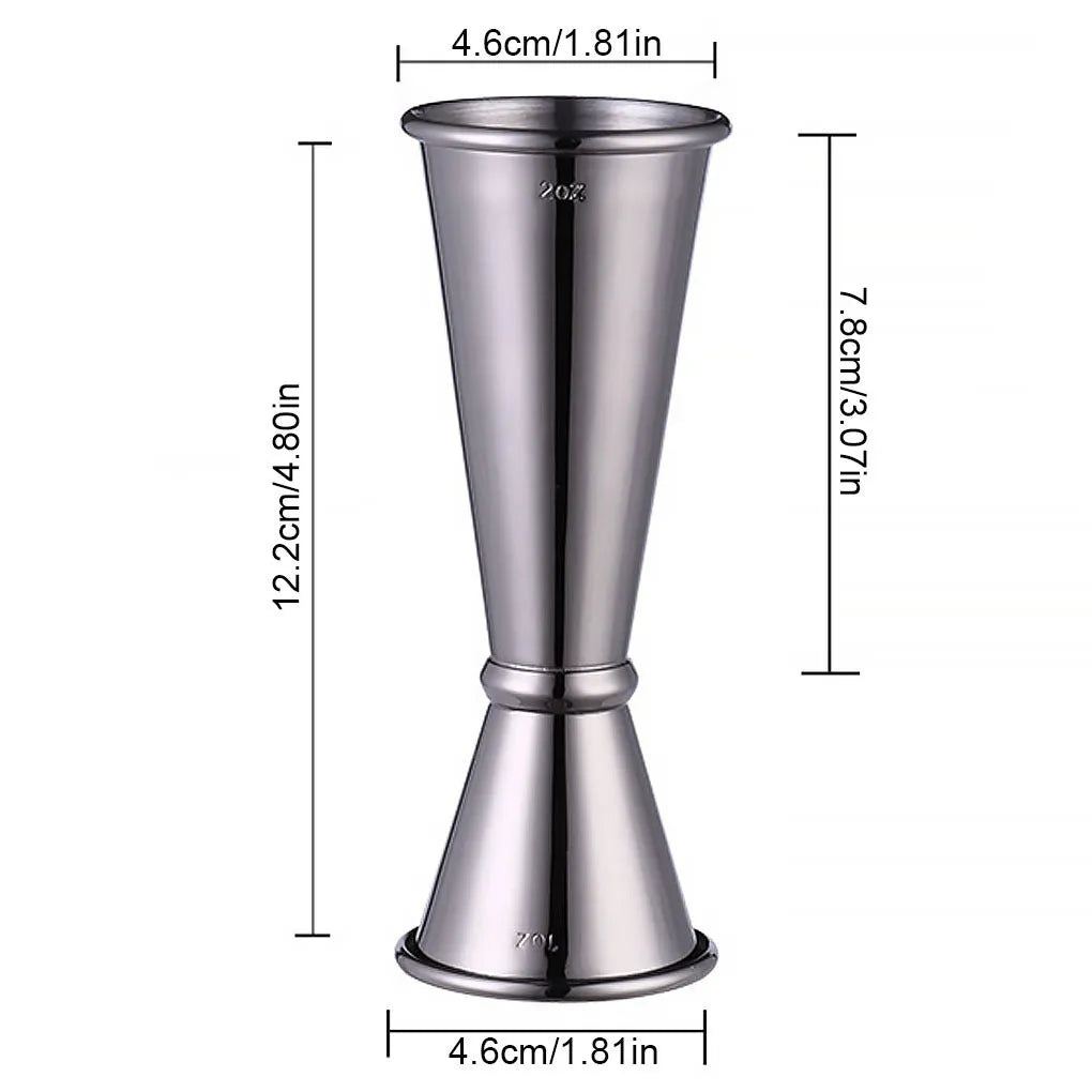 Double-headed stainless steel measuring cup and shaker on a bar counter for cocktail preparation