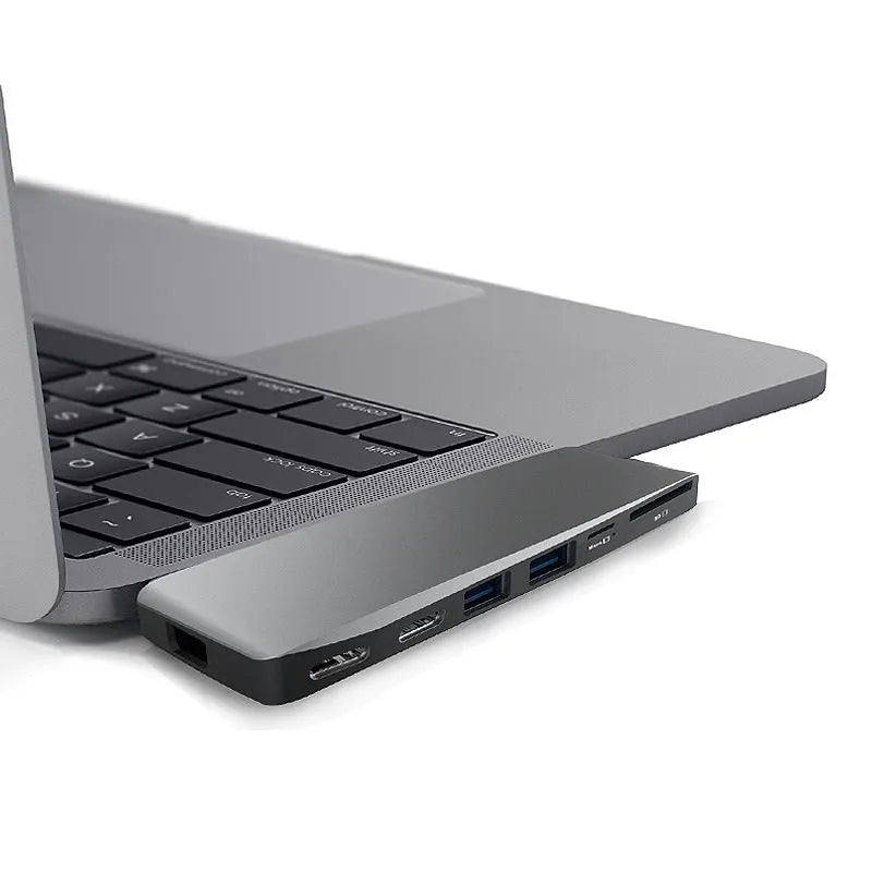 Silver 8-in-1 USB-C hub for MacBook Pro with multiple ports including USB 3.0, HDMI, and card slots