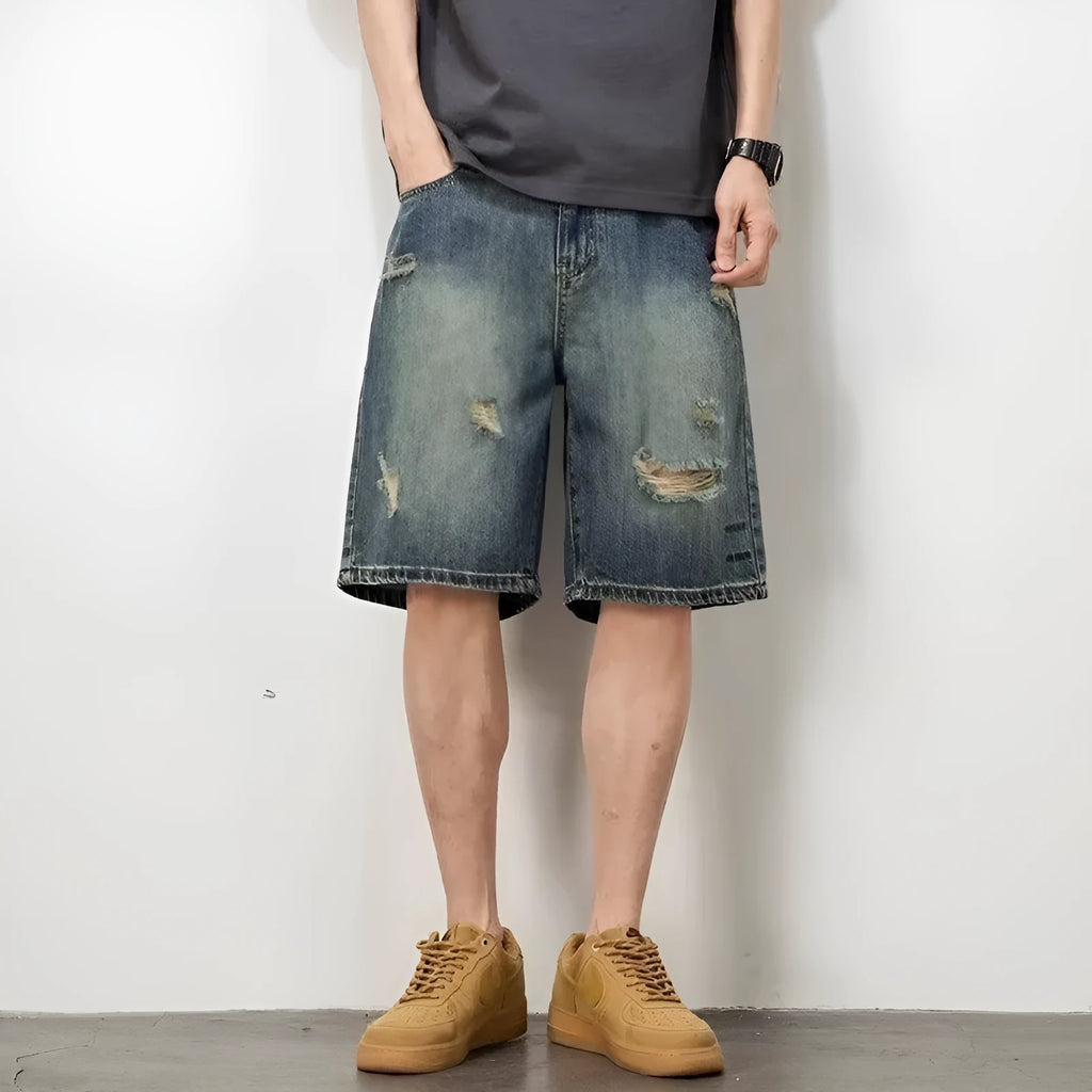 Blue retro-style men's denim shorts with a loose fit, distressed holes, and a straight-leg cut.