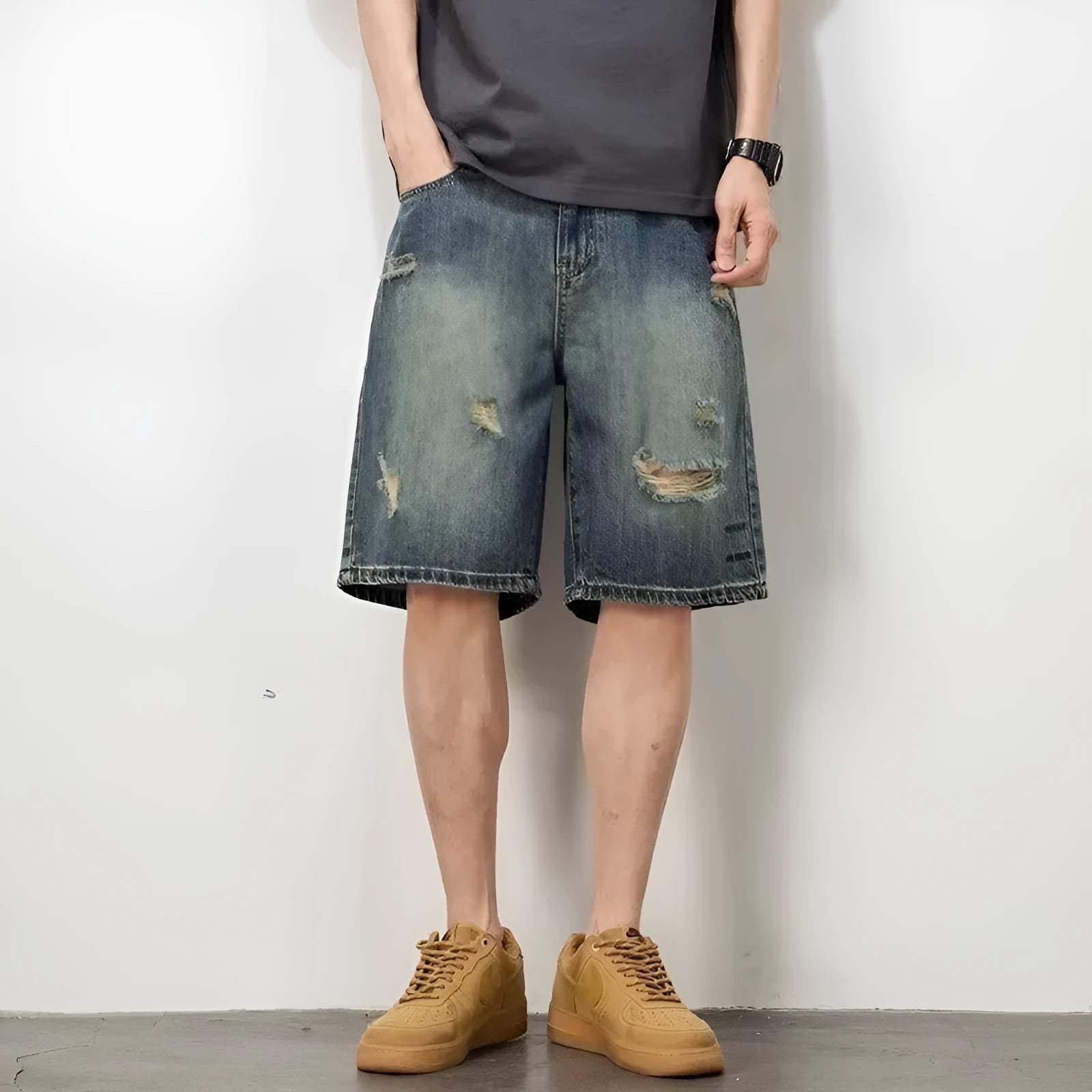 Blue retro-style men's denim shorts with a loose fit, distressed holes, and a straight-leg cut.