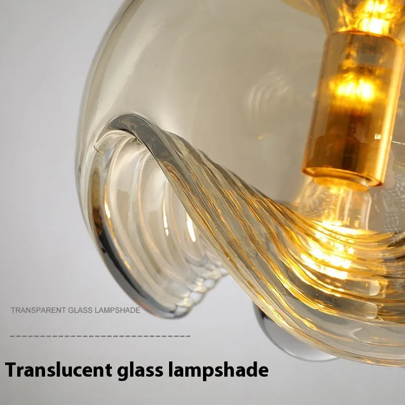 Modern minimalist glass pendant chandelier with a 25cm diameter, shown in transparent, amber, and smoky grey colour options.