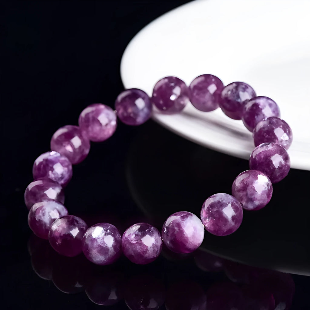 Purple polished crystal beaded bracelet with geometric beads on a white background.