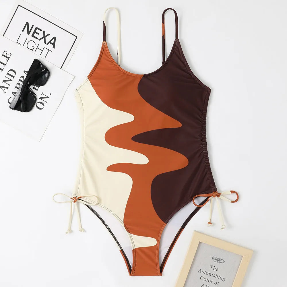 Blue women's sleeveless backless one-piece swimsuit with a striped print, made from polyester and nylon fabric.