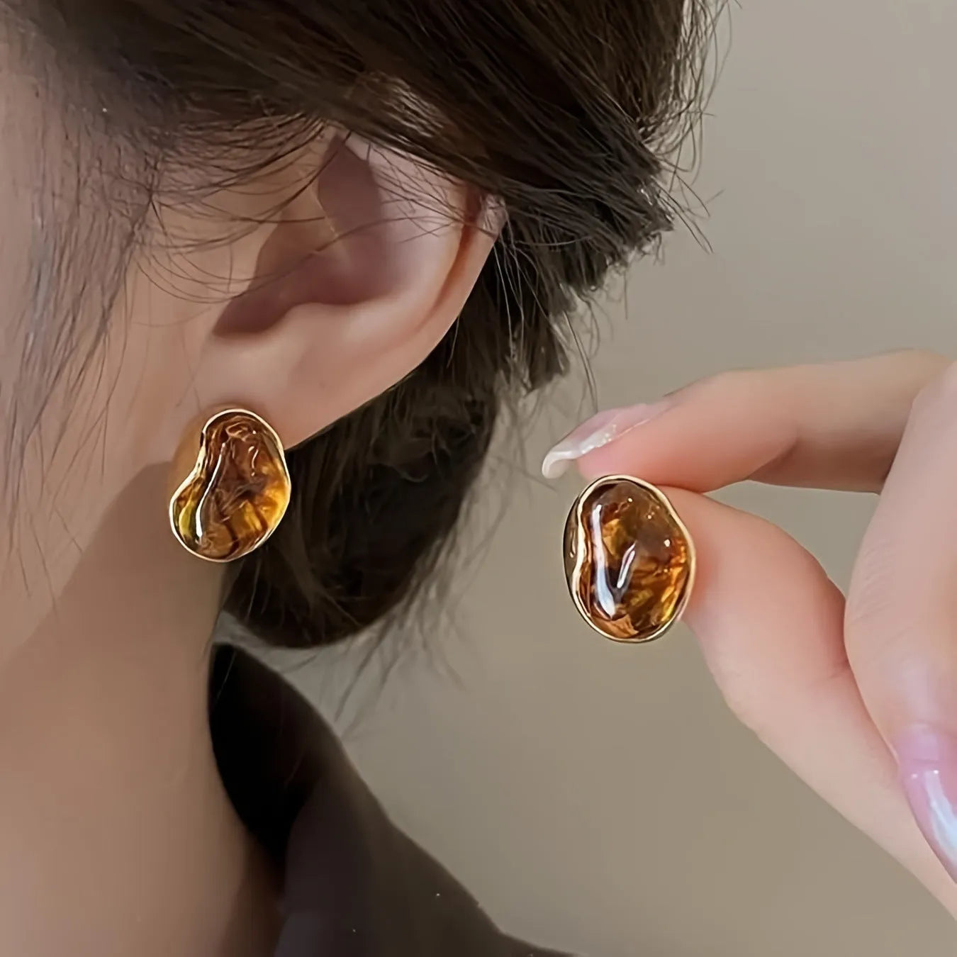 Three pairs of handmade geometric ear studs with electroplated alloy construction and tassel detailing in different colour treatments