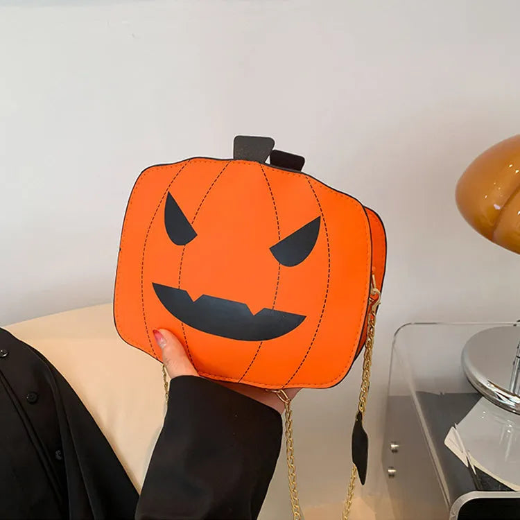 Cartoon pumpkin shoulder bag in orange with chain strap on white background