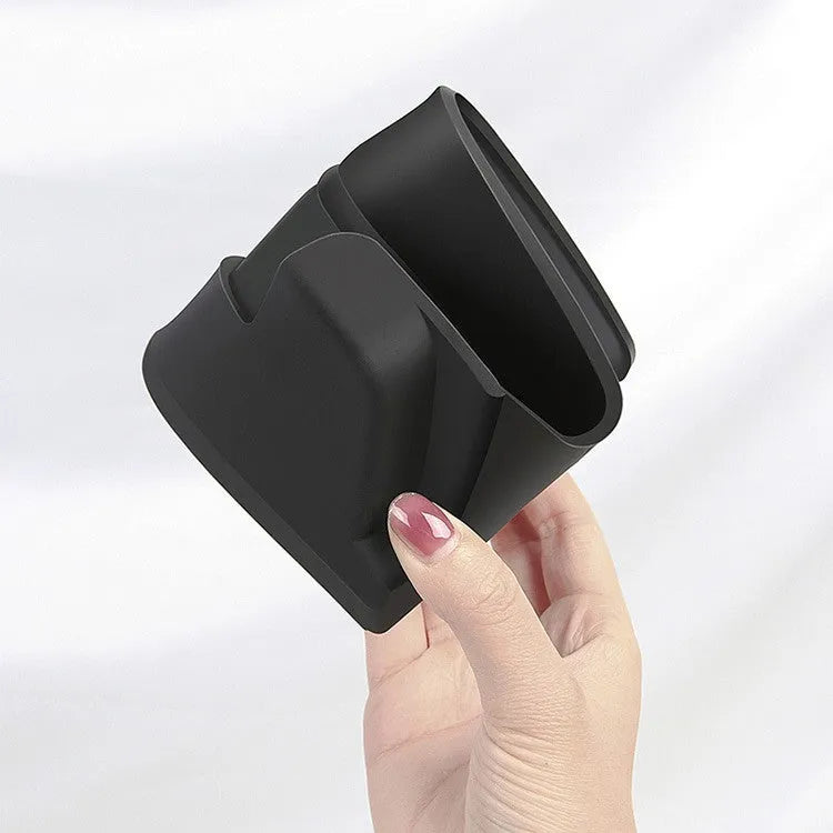 Black silicone glasses storage case installed in a Tesla Model 3 or Y centre console armrest.