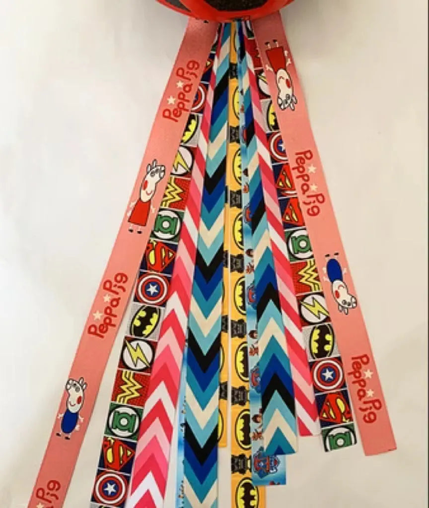 Colourful decorative ribbon streamers attached to a children safety helmet for skating or skiing