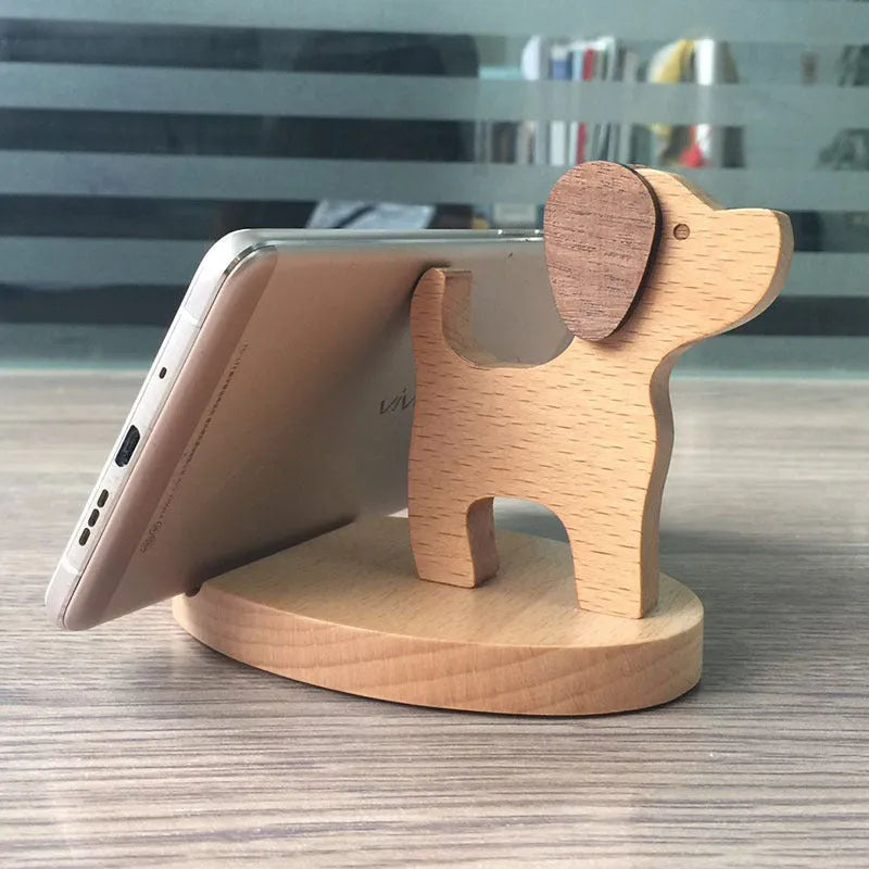Beech wood mobile phone holder stand with coin slot and decorative carving.