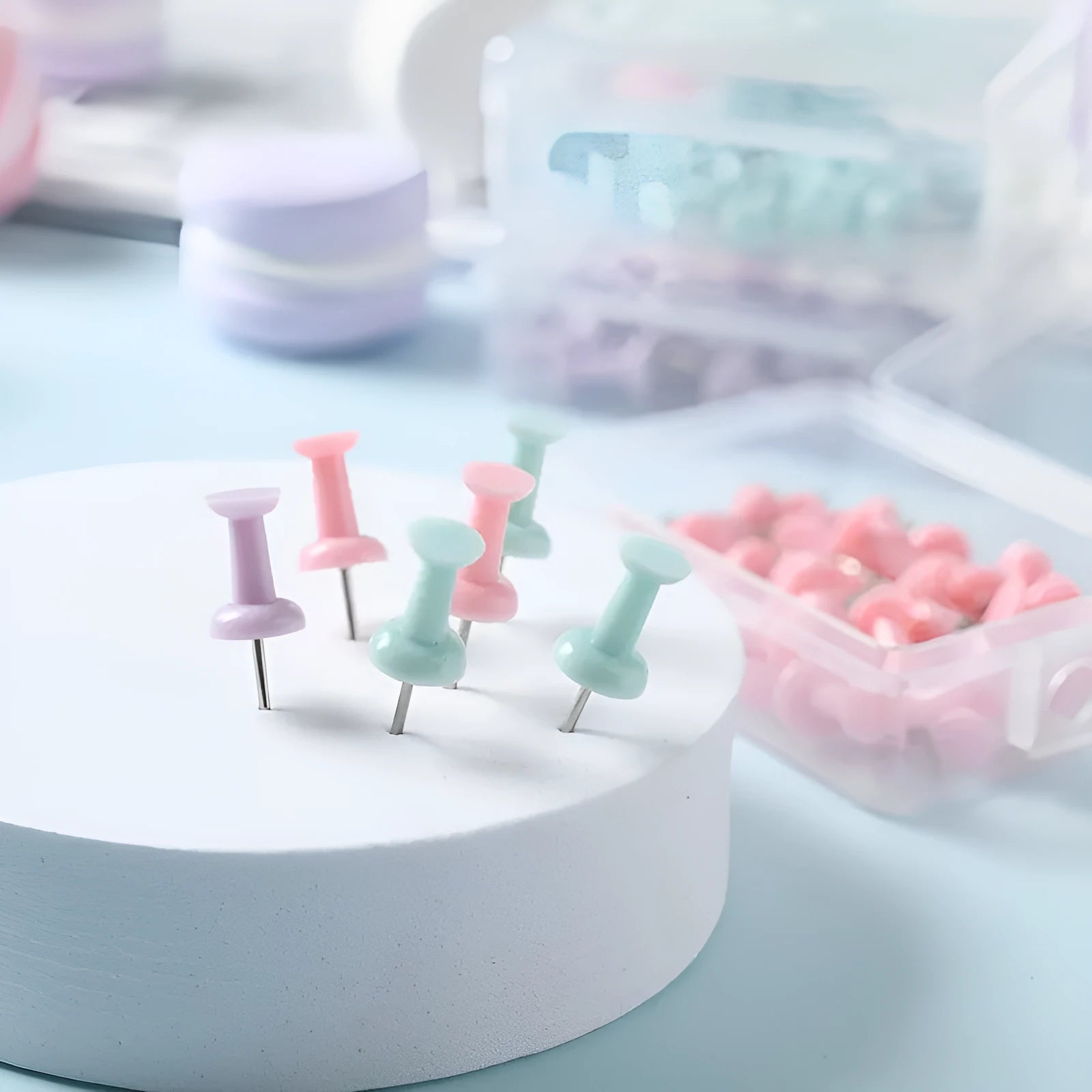 Plastic push pins in cherry blossom pink, mint green, and lavender, showing large and small sizes in a box.
