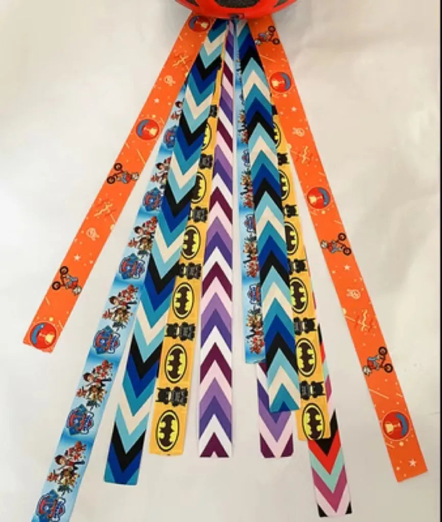 Colourful decorative ribbon streamers attached to a children safety helmet for skating or skiing