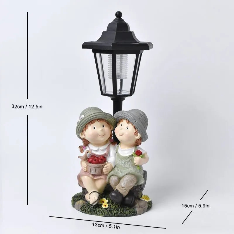 Solar hexagonal garden lamp with decorative resin figurine on plastic base for outdoor pathway lighting