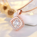 Women's silver heart-shaped pendant necklace with crown and bow decoration on a delicate chain.