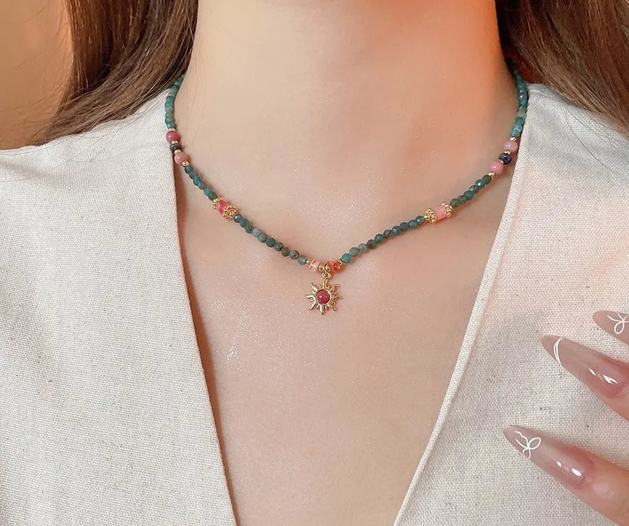 French royal court style necklace with freshwater pearls and a stone sun pendant on an adjustable chain.
