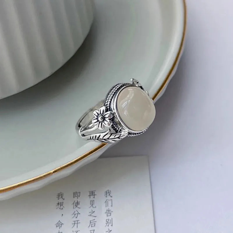 Adjustable copper vintage ring with white chalcedony stone and U-shaped band.