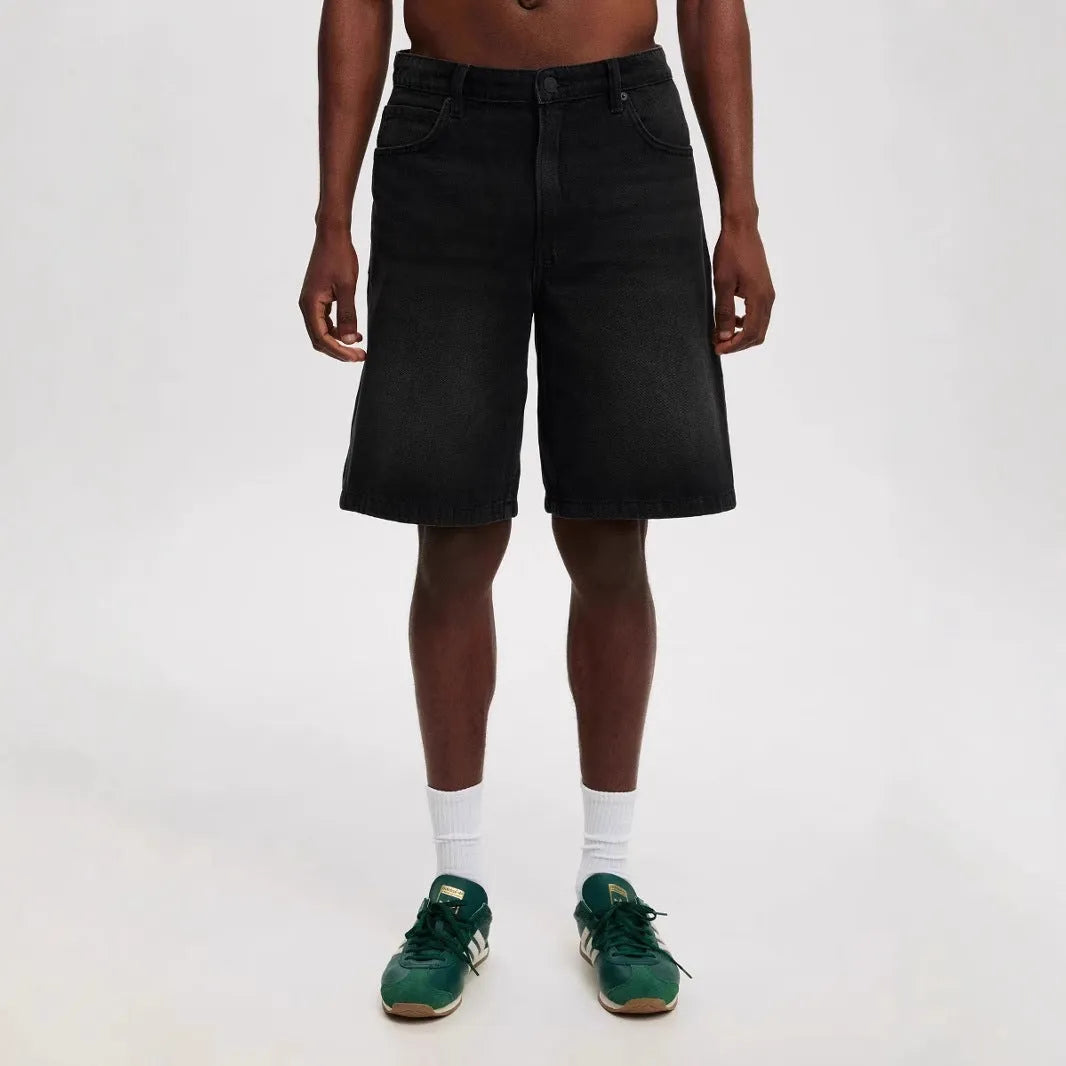 Man wearing loose fit light blue straight leg denim jeans, a streetwear summer style.