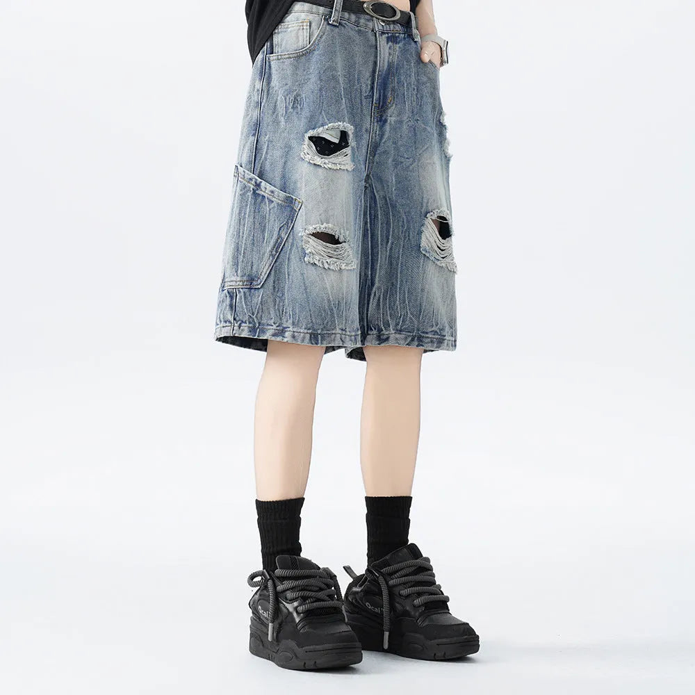 Washed denim shorts with ripped detailing in loose retro style, available in black or blue