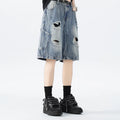 Washed denim shorts with ripped detailing in loose retro style, available in black or blue