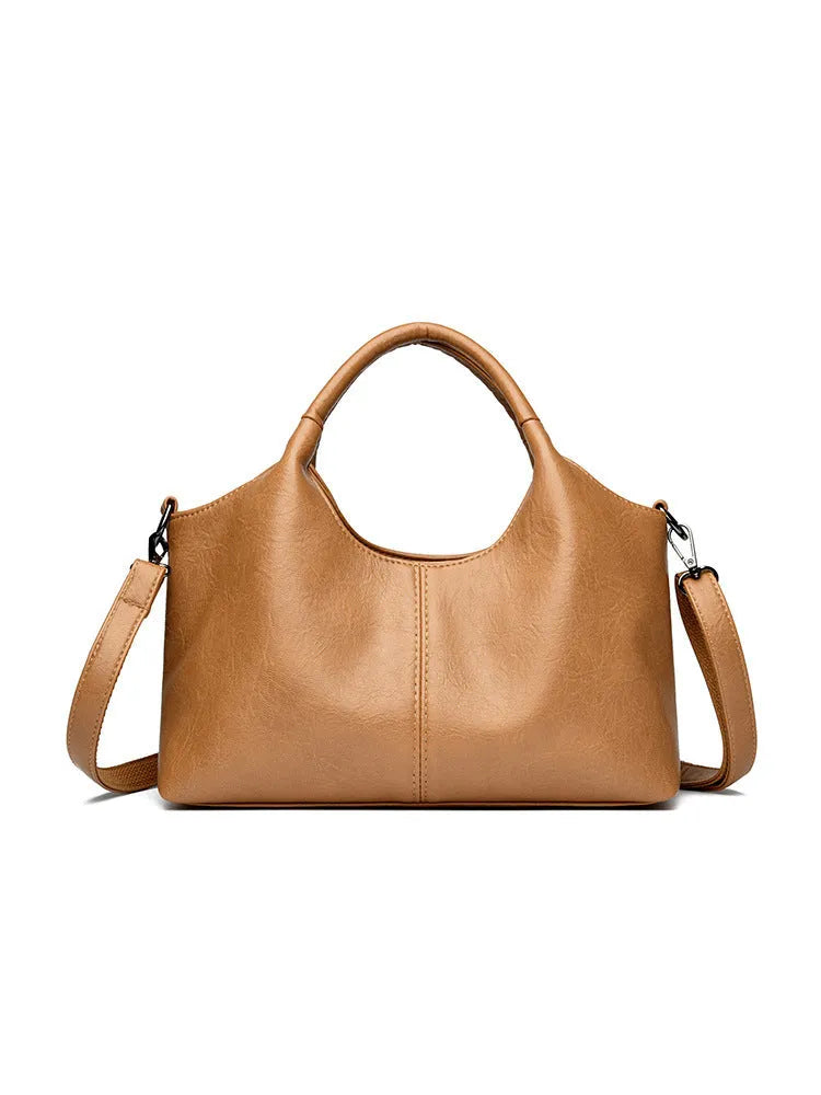 Women's genuine leather crossbody bag in beige colour showing soft construction and large capacity