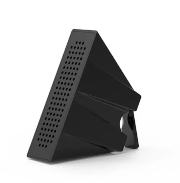 A small, coloured plastic phone amplifier holder holding a mobile phone on a desk.