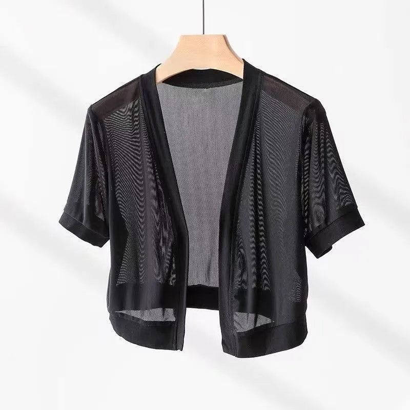 Women's black French-style shirt with irregular collar, long bell sleeves, and a front tie detail.