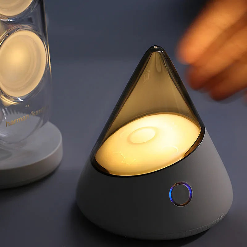 Colourful small geometric night lamp with built-in battery and Type-C charging cable on a wooden shelf