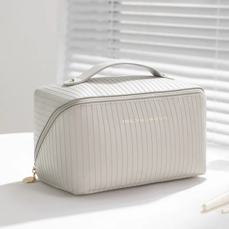 Vertical pattern pillow makeup bag in cubic design measuring 22.5cm height with travel storage capacity